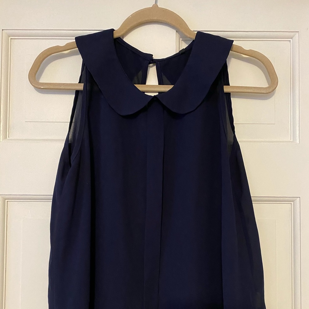 Navy blue collared top with pearl button back.
